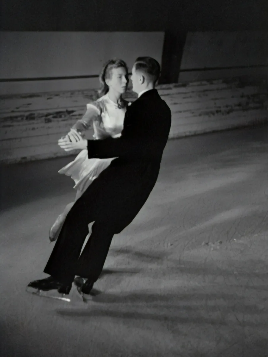 Un couple de patineurs enlacés sur la glace, photo ancienne en noir et blanc